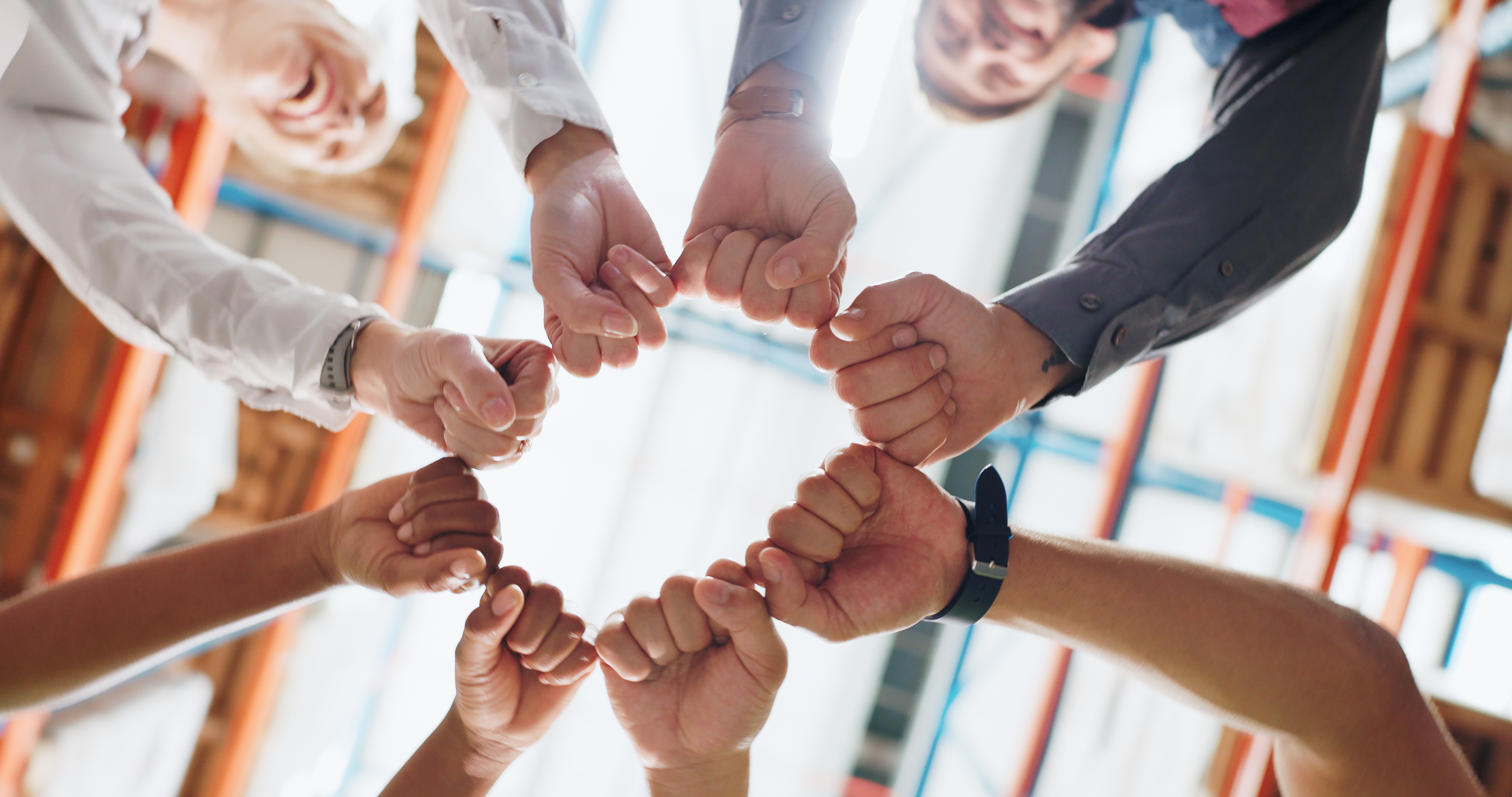 People putting their hands in a circle